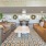 a large living room with a large chandelier and a large couch