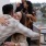 friends hugging on a rooftop