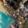 a group of people standing around a pool