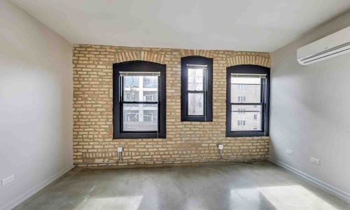 modern apartment living room with air conditioning unit and sunlight streaming through windows - air conditioning unit cost apartment