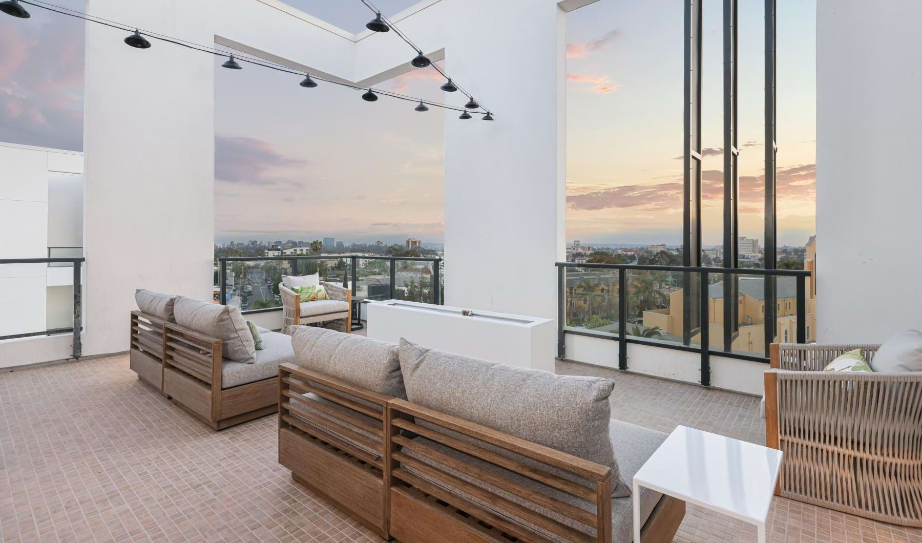 a room with a large window and a couch and a table