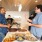 a group of people in a kitchen