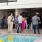 a group of people standing around a pool